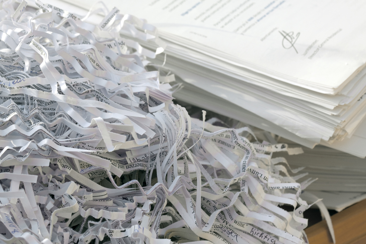 Confidential documents being shredded Us-China trade war representation with import and export containers clashing
